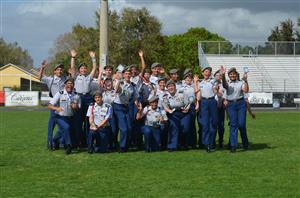 Image of JROTC students holding a trophy 